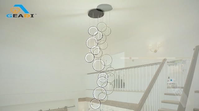 Black 10-ring spiral LED chandelier in a modern Australian high-ceiling staircase