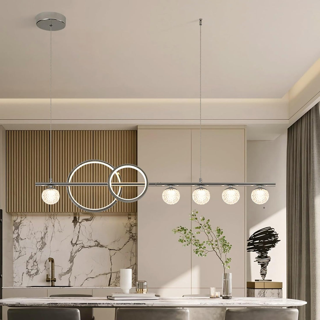 Tiered crystal chandelier lit above a dining table in an Australian home, showing drop height and diameter