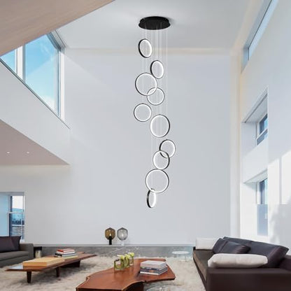 Black 10-ring spiral LED chandelier in a modern Australian high-ceiling staircase