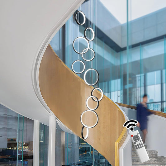 Black 10-ring spiral LED chandelier in a modern Australian high-ceiling staircase