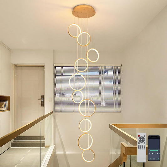 Gold 10-ring spiral LED chandelier in a modern Australian high-ceiling staircase