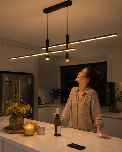 Warm dimmable linear LED pendant light over a kitchen island in a modern Australian home at night