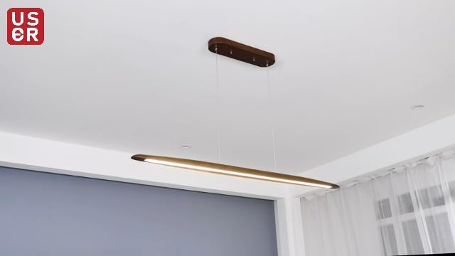 Walnut wood linear LED pendant light over a kitchen island in a modern Australian home