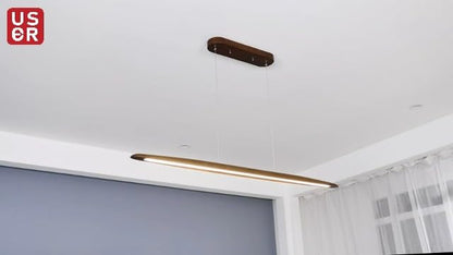 Walnut wood linear LED pendant light over a kitchen island in a modern Australian home
