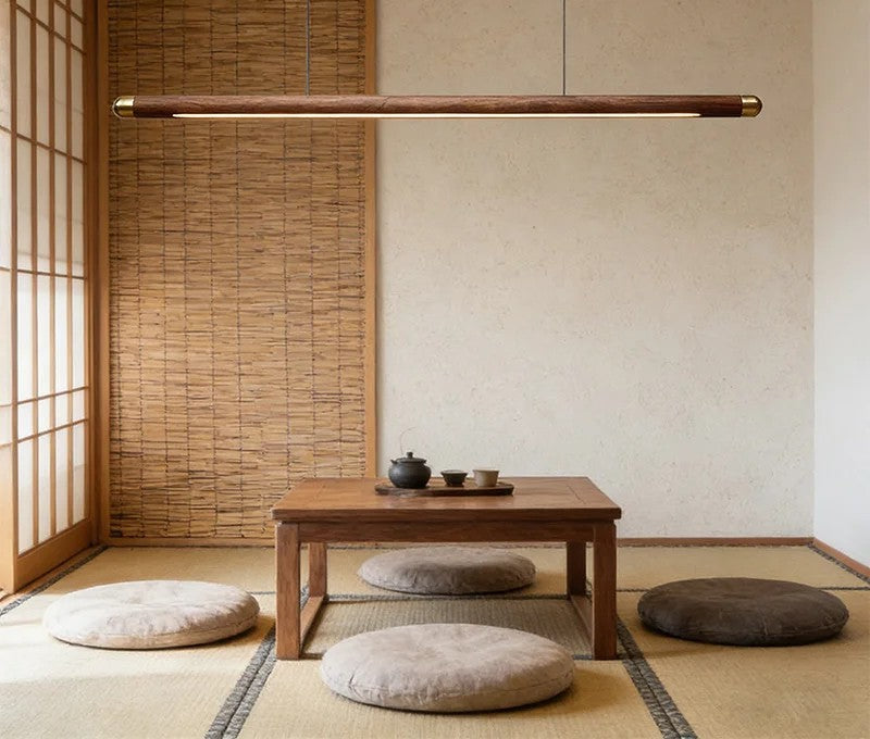 Minimalist walnut wood linear LED pendant light over a dining table in a modern Australian home